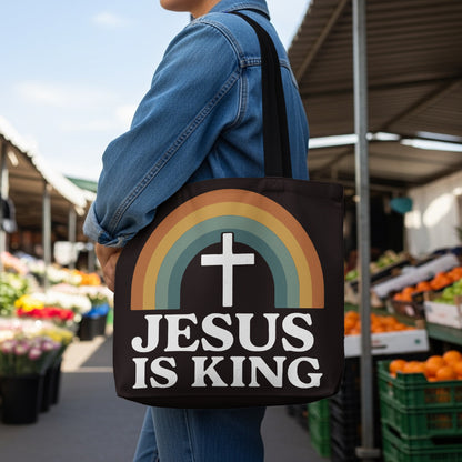 Black tote bag with rainbow and white cross; "Jesus Is King" text.