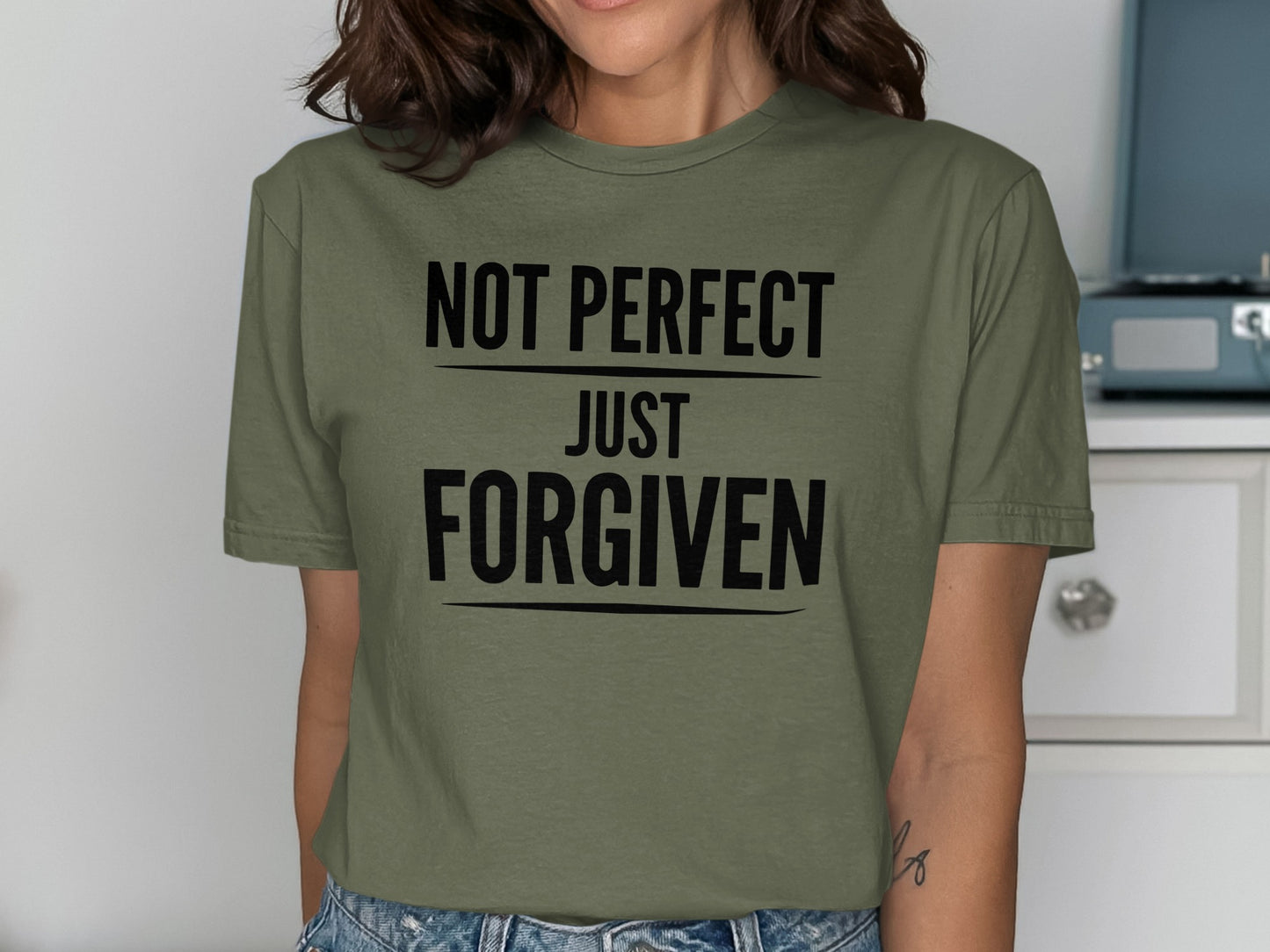 Green t-shirt with black text reading "NOT PERFECT JUST FORGIVEN".