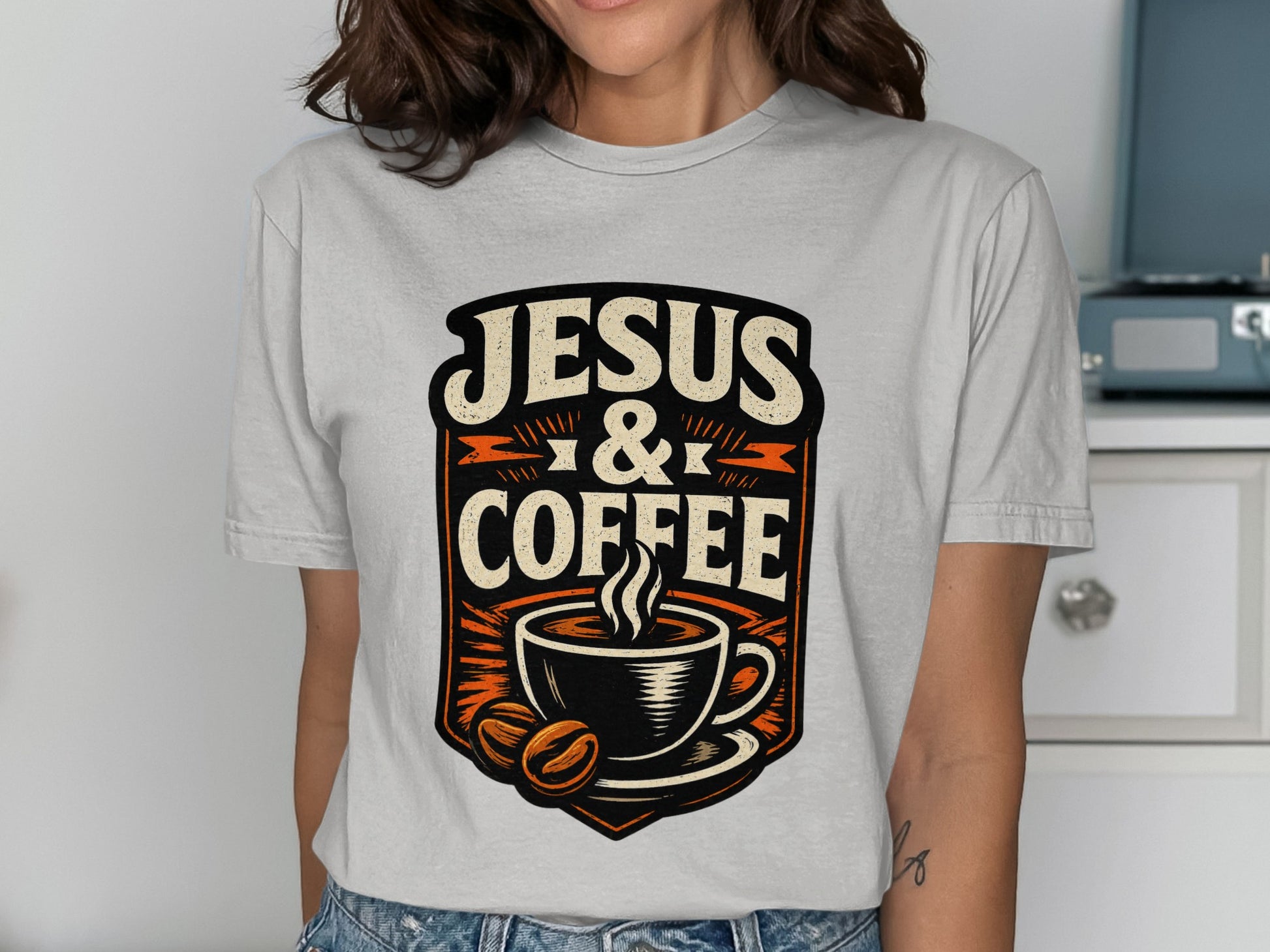 Jesus & Coffee graphic with steaming mug and coffee beans on a t-shirt.