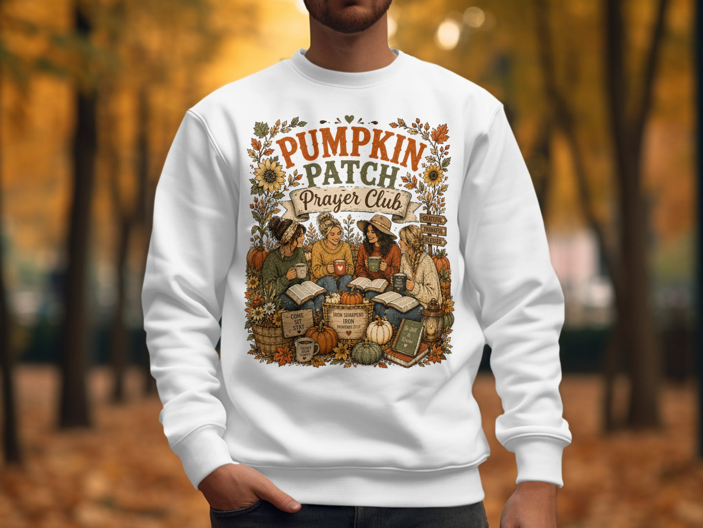 White sweatshirt with "Pumpkin Patch Prayer Club" graphic and autumn motifs.