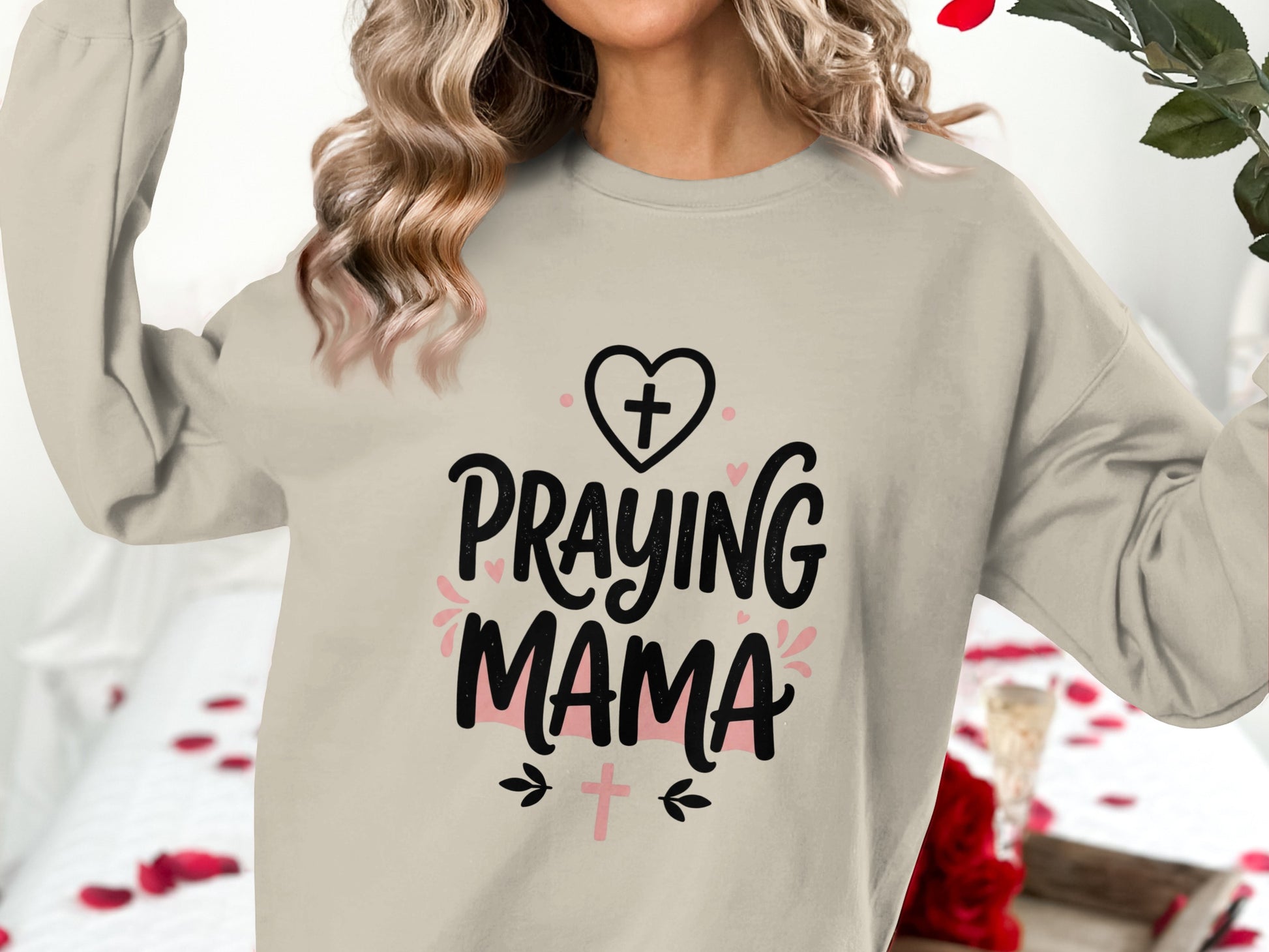 Crewneck sweatshirt with "Praying Mama" text and cross graphics.