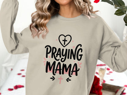 Crewneck sweatshirt with "Praying Mama" text and cross graphics.