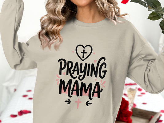Crewneck sweatshirt with "Praying Mama" text and cross graphics.