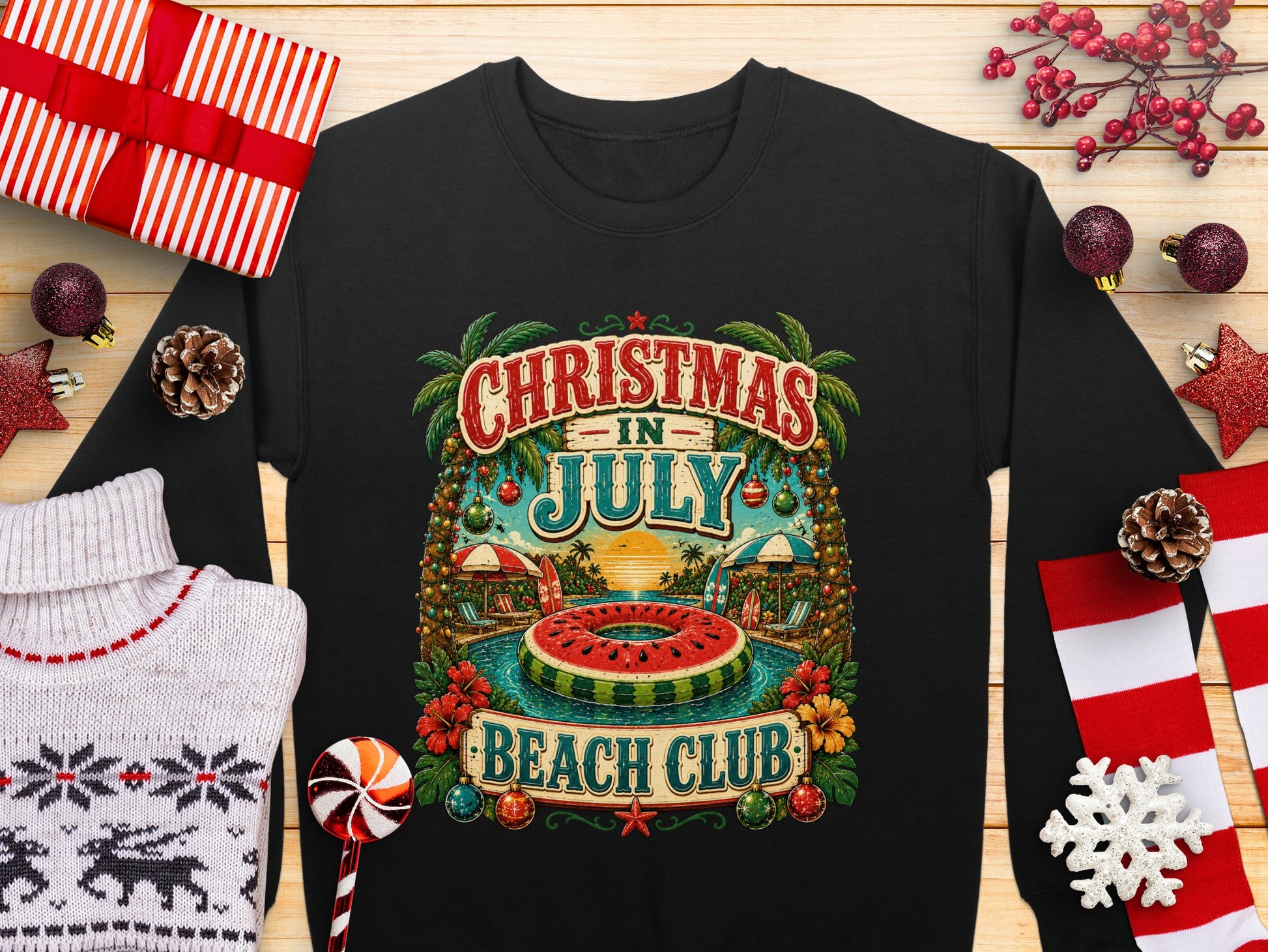 Black sweatshirt with "Christmas in July Beach Club" graphic and tropical beach scene.
