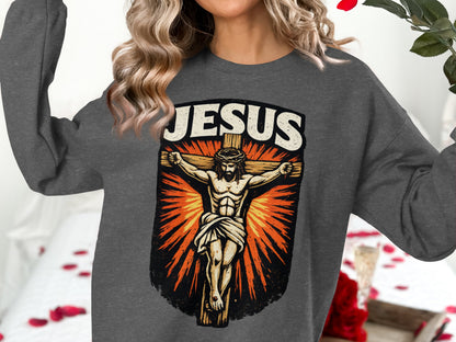 Jesus Christ on the cross graphic on a dark gray crewneck sweatshirt.