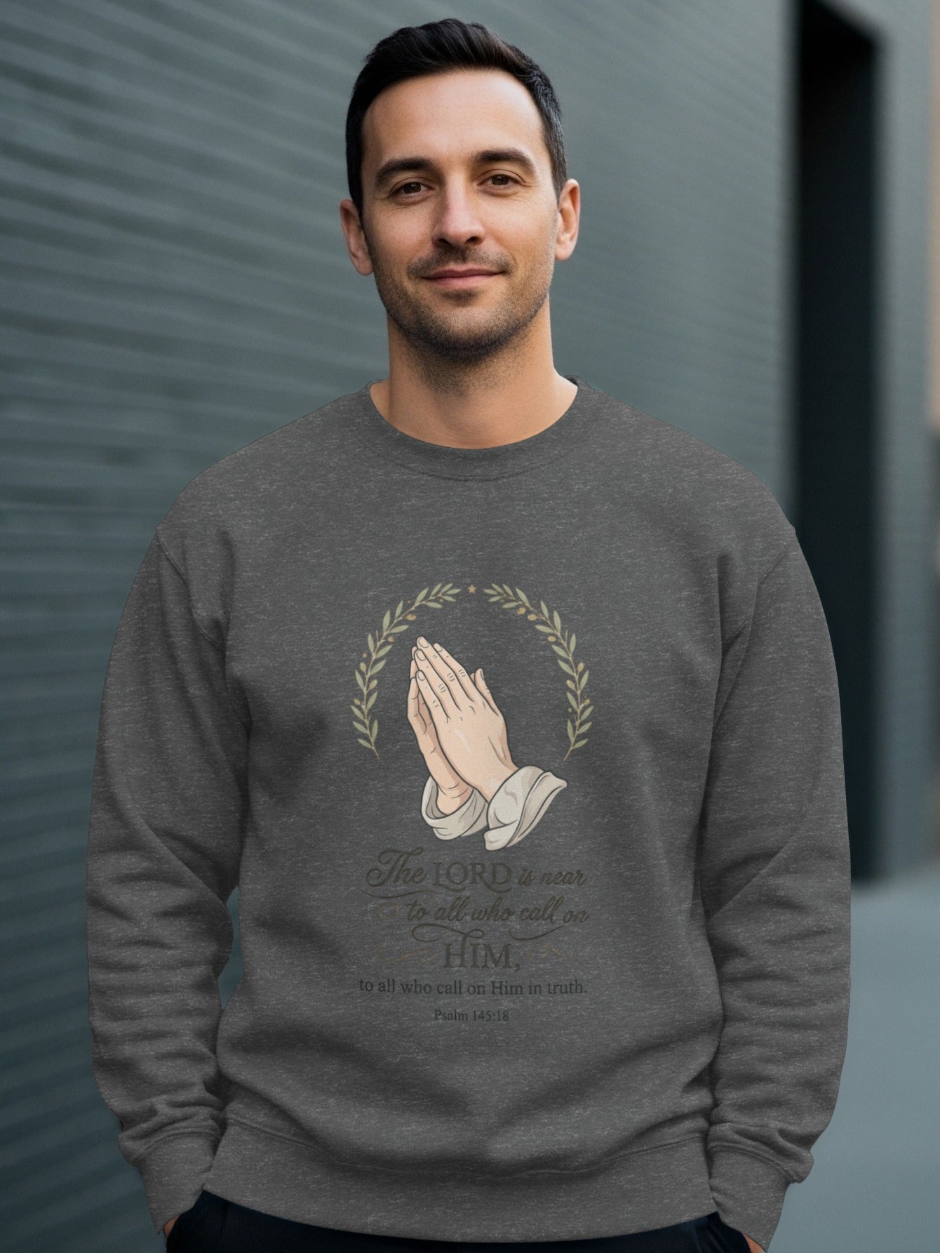 Man in dark gray sweatshirt with praying hands and "The LORD is near" scripture.