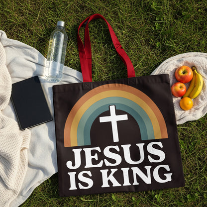 Black tote bag with rainbow and "Jesus is King" text.