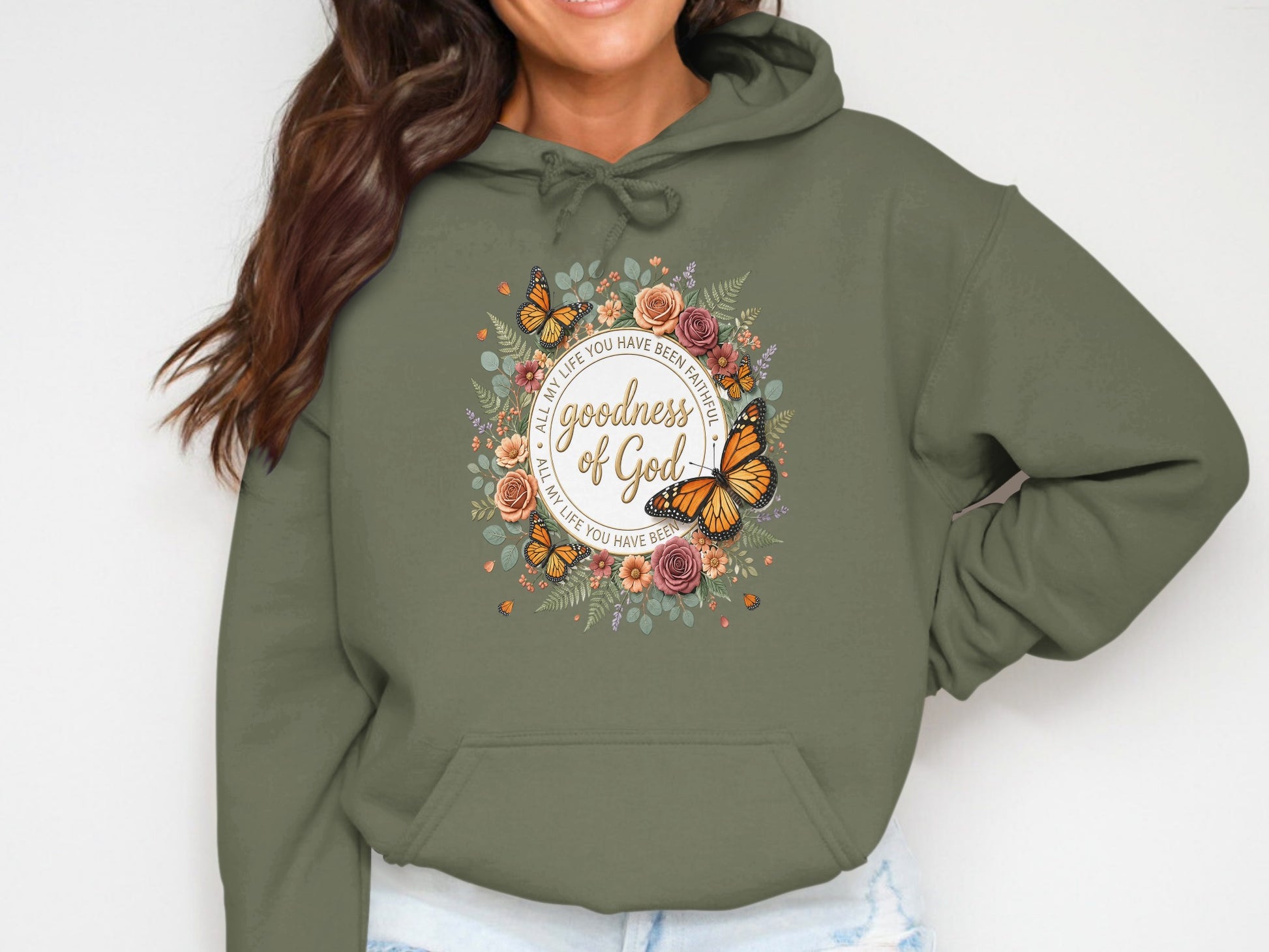 Olive green hoodie with floral and butterfly design, featuring "Goodness of God" text.