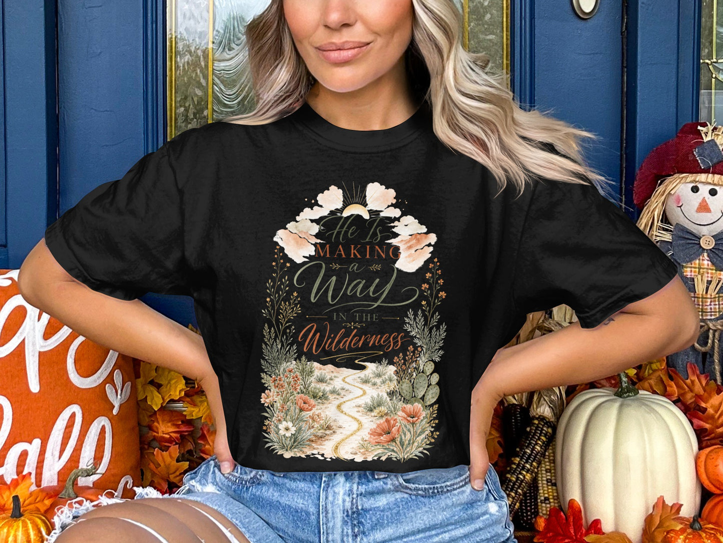 Black t-shirt with "He Is Making a Way in the Wilderness" graphic.