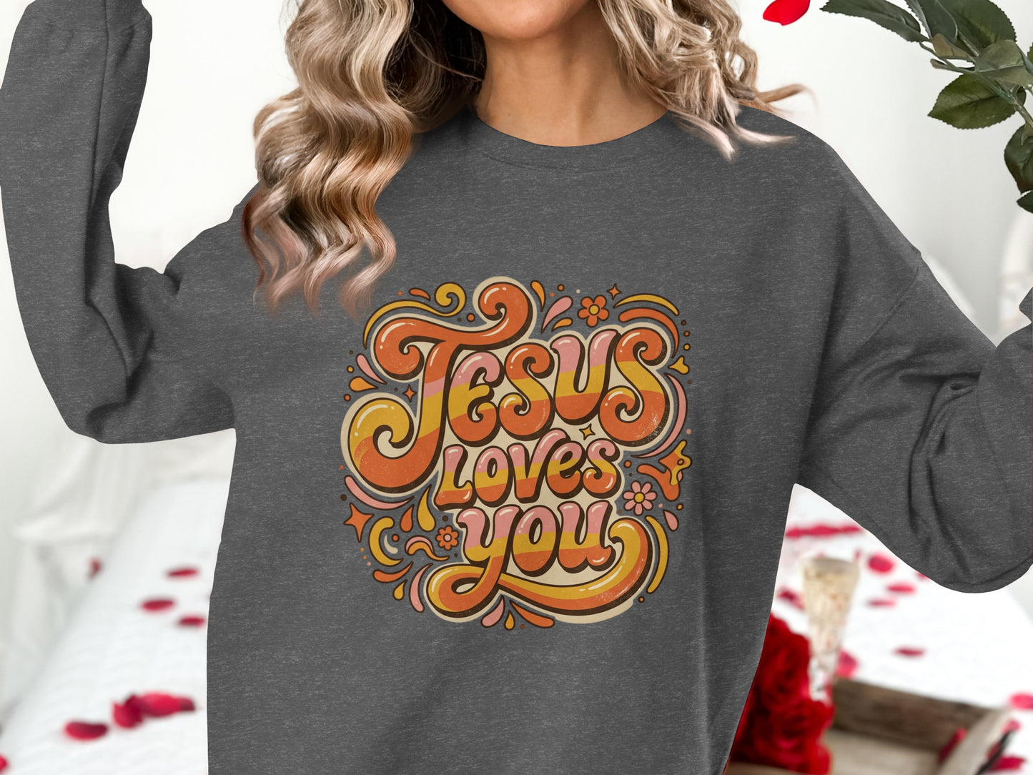 Dark gray sweatshirt with "Jesus Loves You" in retro groovy font.