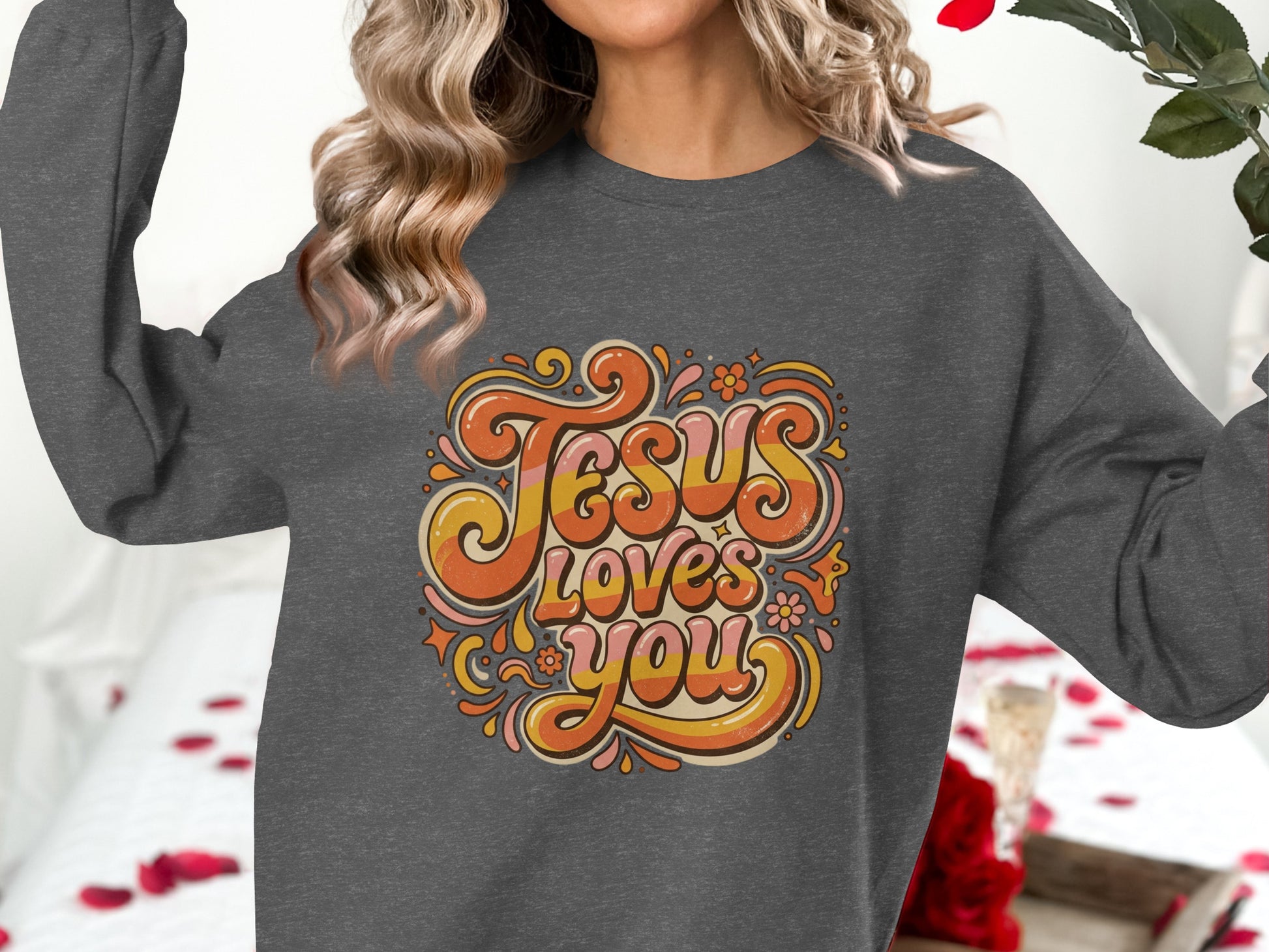 Dark gray sweatshirt with "Jesus Loves You" in retro groovy font.