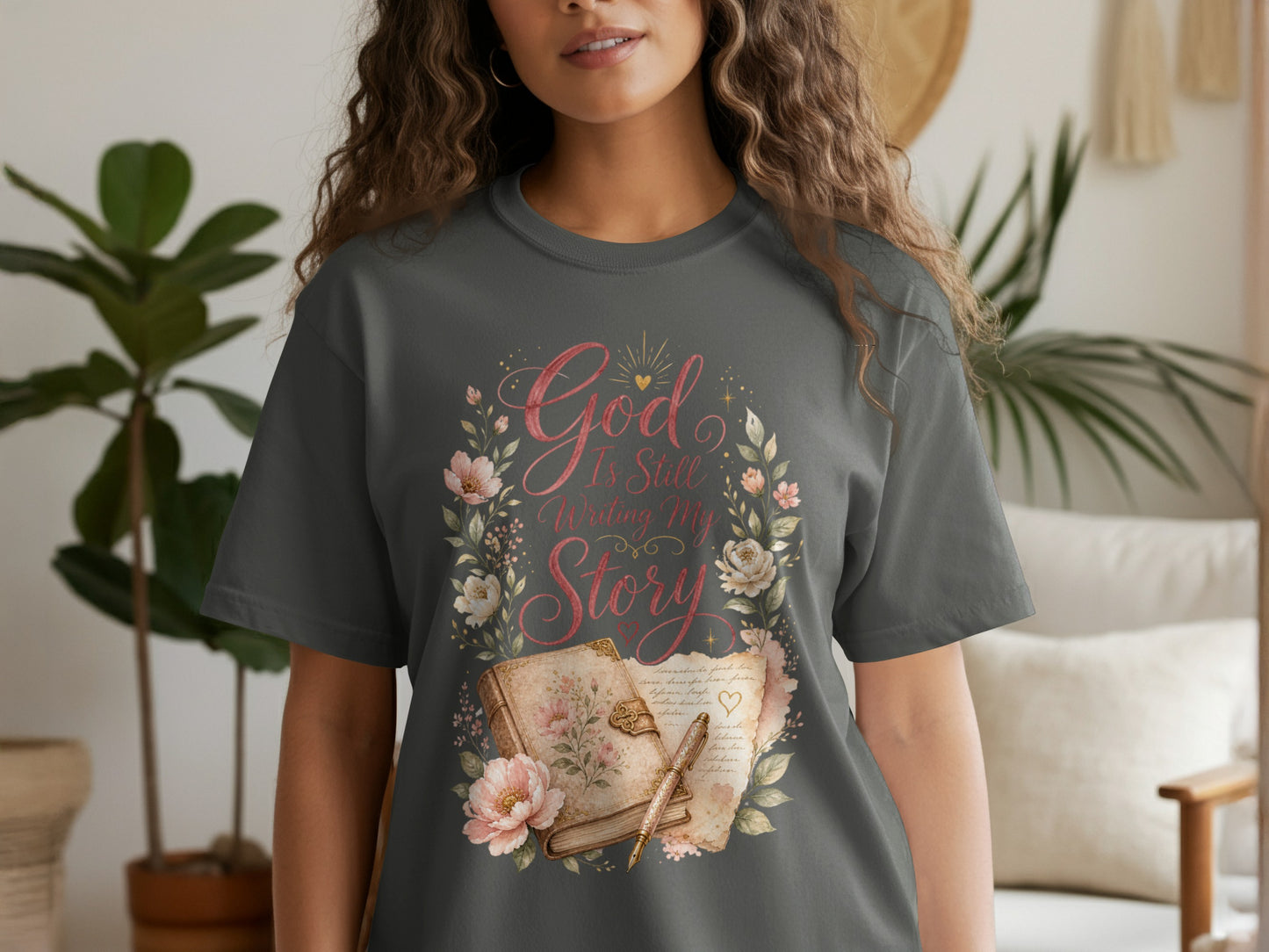 Dark gray t-shirt with floral design and text "God Is Still Writing My Story."