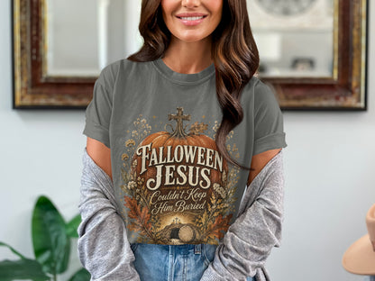 Gray t-shirt with "Fallown Jesus Couldn't Keep Him Buried" text and tomb graphic.