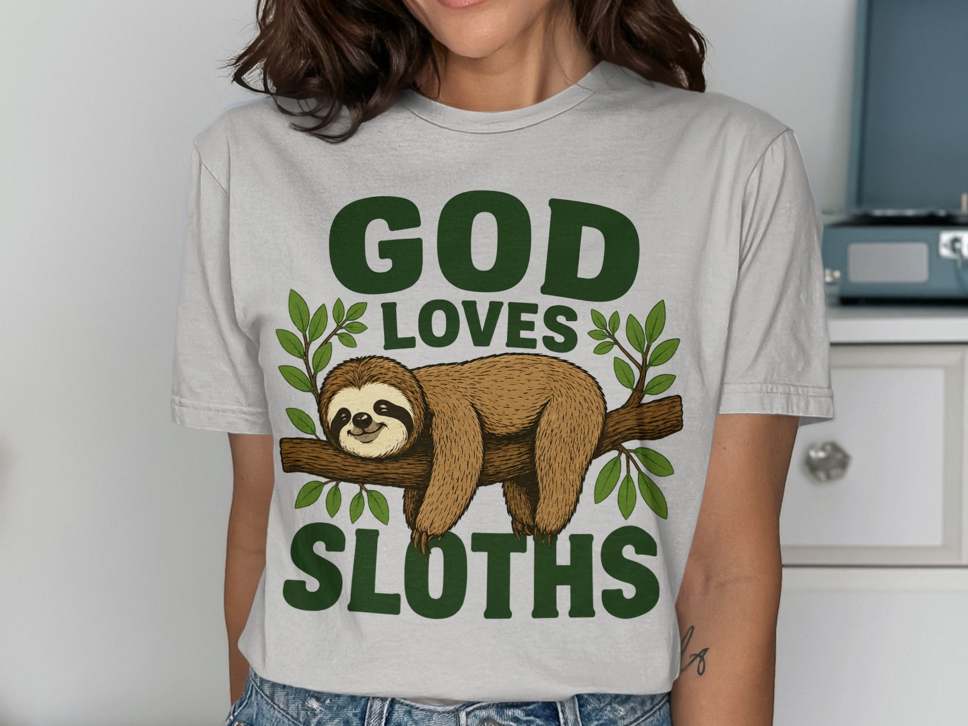 Grey t-shirt with "GOD LOVES SLOTHS" and a sloth on a branch.