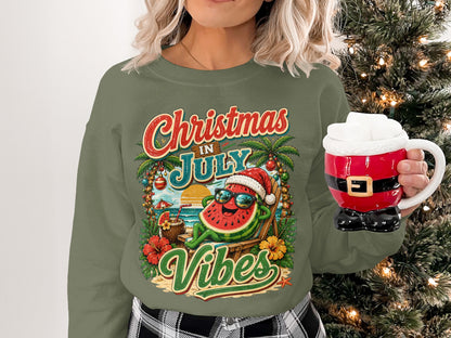 Sweatshirt with "Christmas in July Vibes" text and watermelon Santa on a beach.