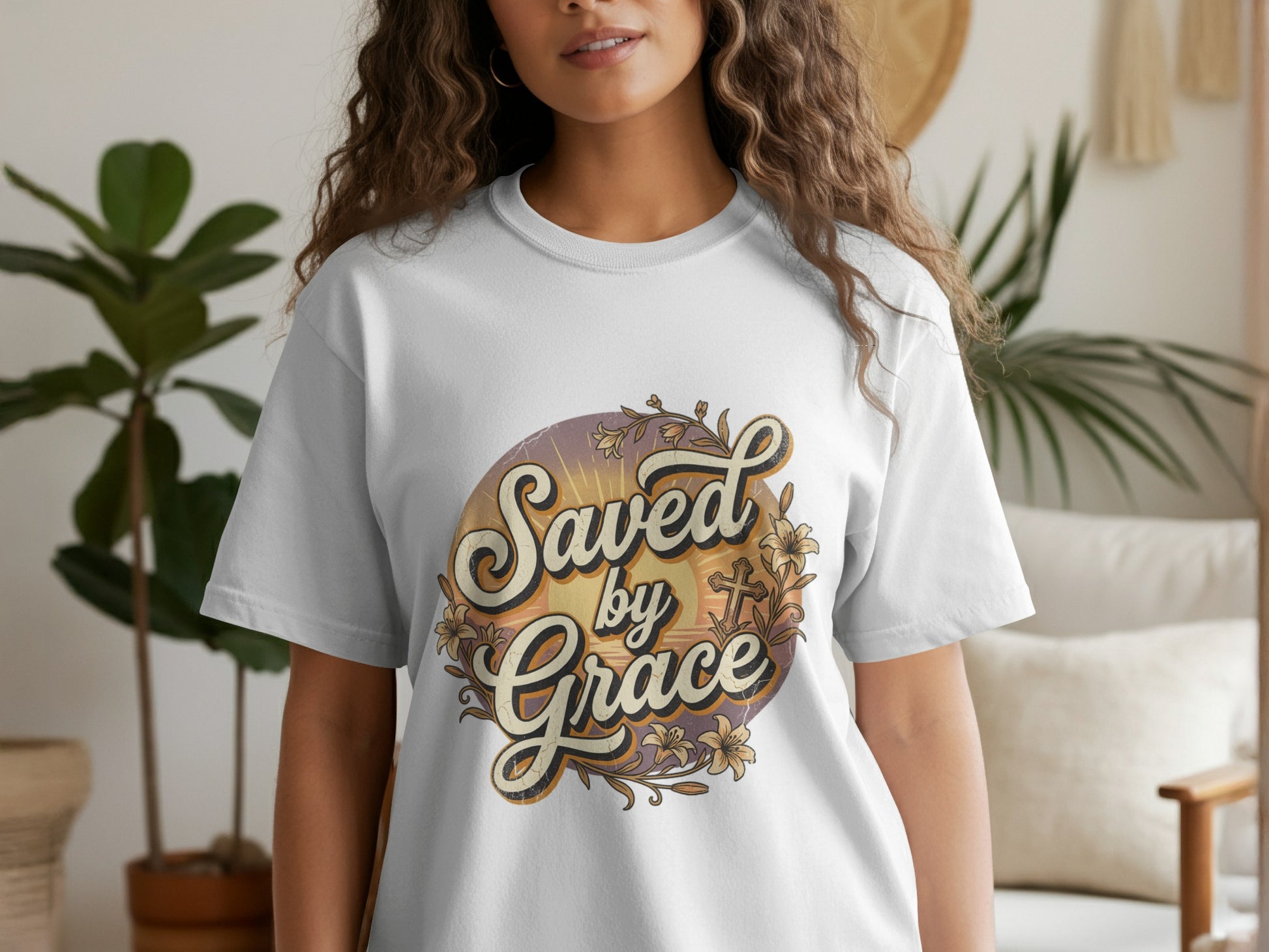White t-shirt with "Saved by Grace" text and floral cross design