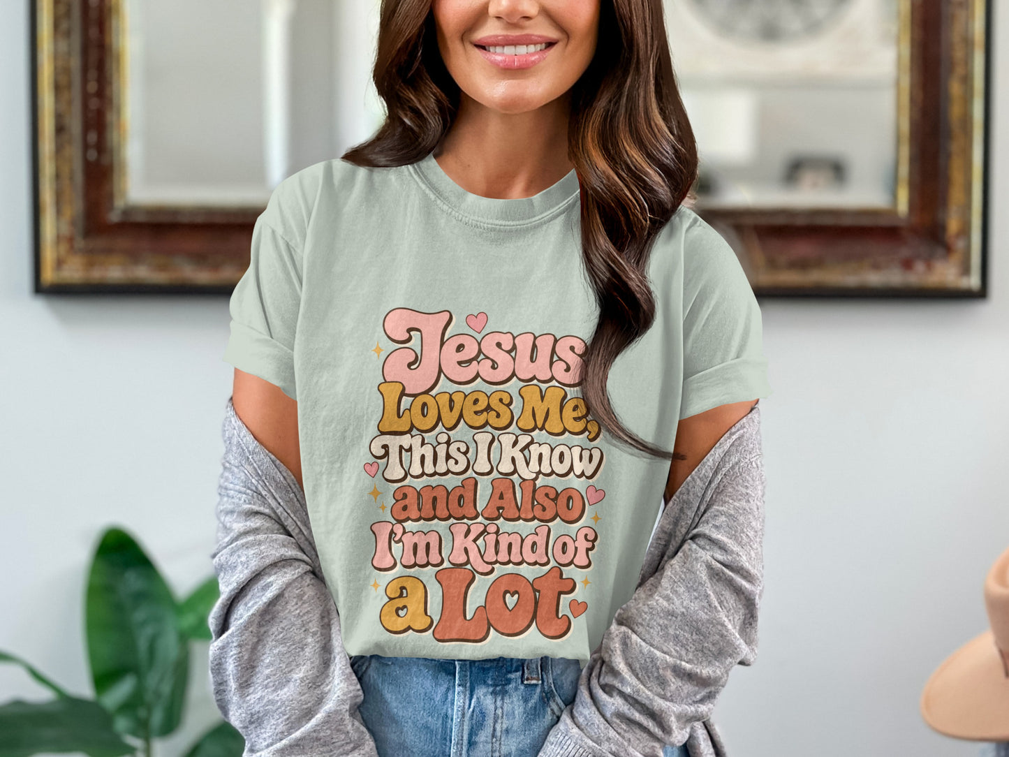 Light green t-shirt with "Jesus Loves Me, This I Know and Also I'm Kind of a Lot" text.