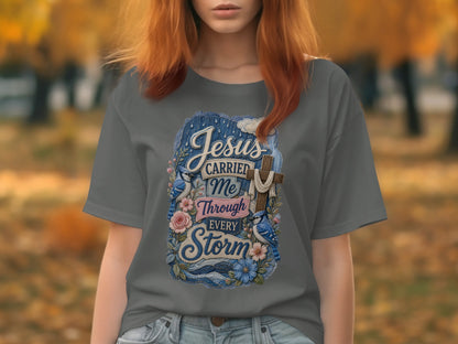 Grey t-shirt with "Jesus Carried Me Through Every Storm" cross and bluebirds design.