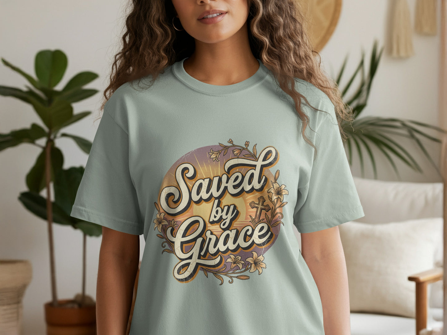 Light teal t-shirt with "Saved by Grace" text and floral cross design.