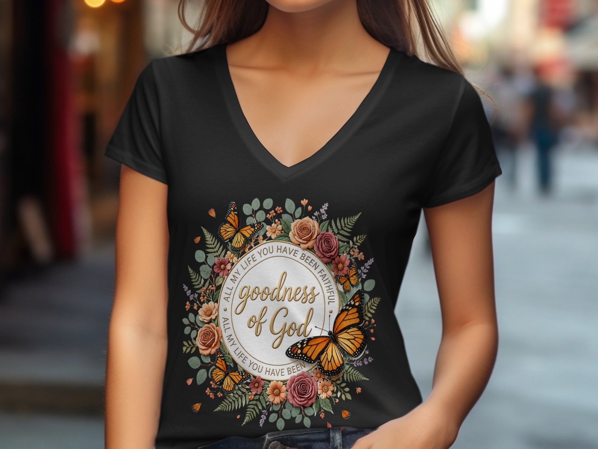 Black t-shirt with floral circle design featuring "goodness of God" and butterflies.