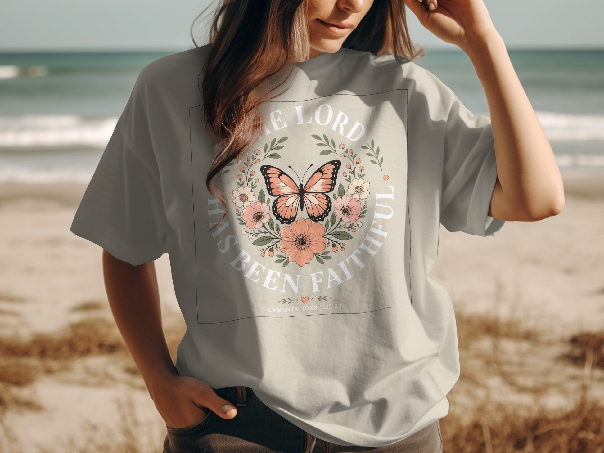 Shirt with floral wreath, butterfly, and "The Lord Has Been Faithful" text.