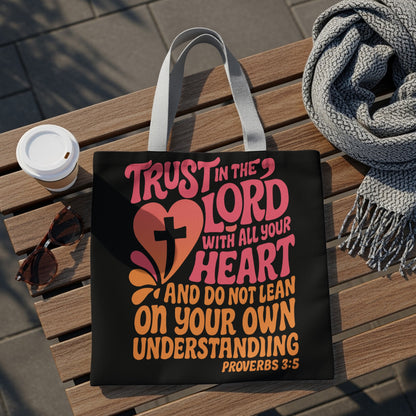 Black tote bag with colorful text and a cross: "Trust in the Lord with all your heart and do not lean on your own understanding. Proverbs 3:5"