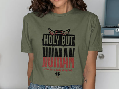 Green t-shirt with "HOLY BUT HUMAN (Yes, it's a daily struggle.) A-MEN" text.