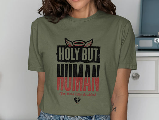 Green t-shirt with "HOLY BUT HUMAN (Yes, it's a daily struggle.) A-MEN" text.