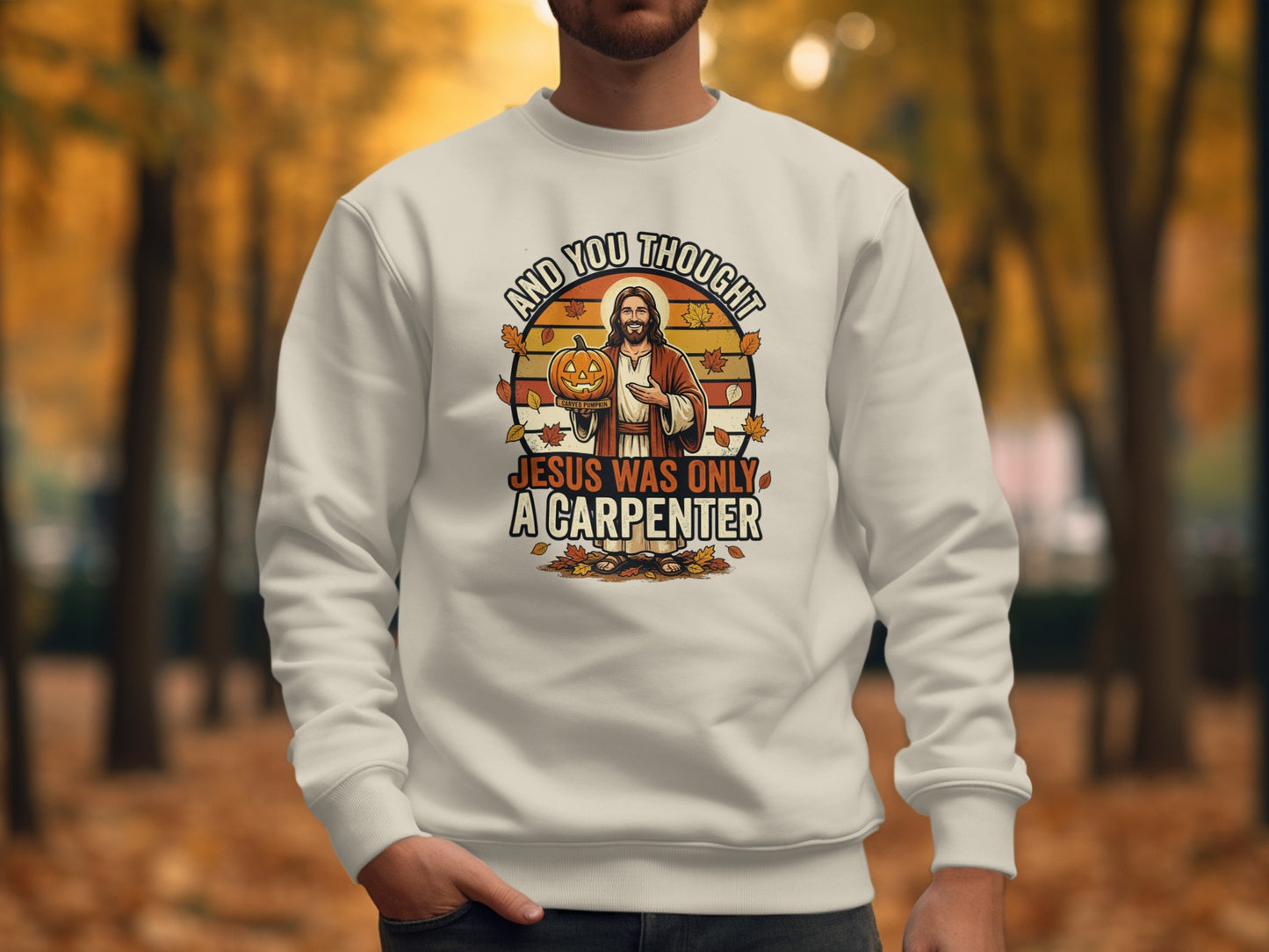 Crewneck sweatshirt with "And you thought Jesus was only a carpenter" Halloween graphic.