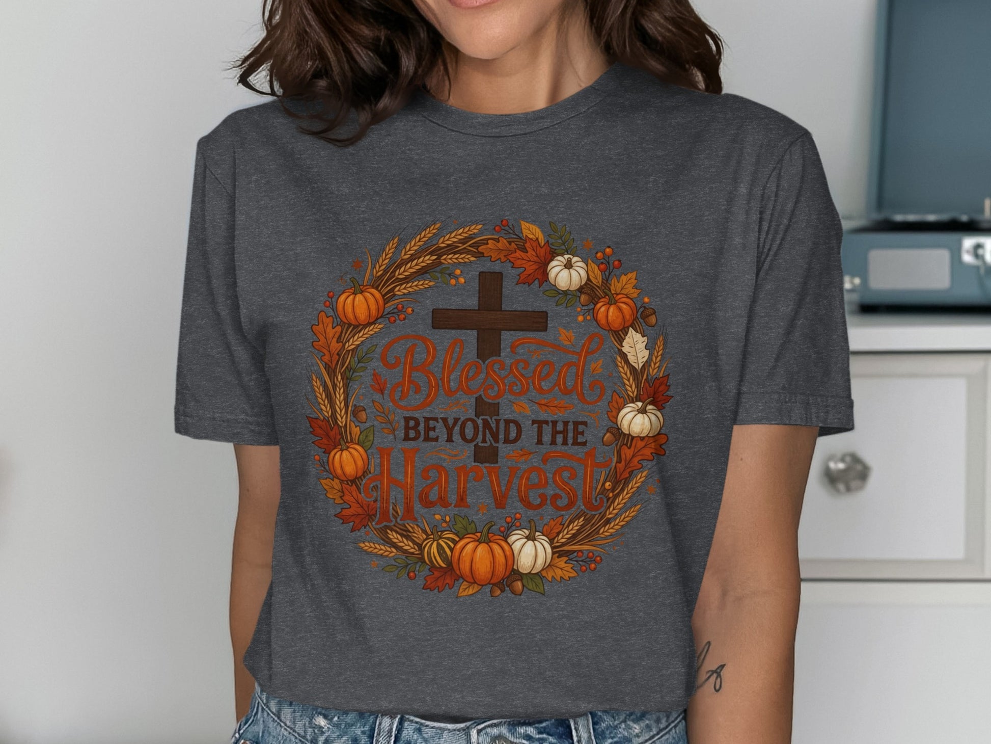 Dark gray t-shirt with a circular harvest-themed design featuring a cross and "Blessed Beyond the Harvest" text.