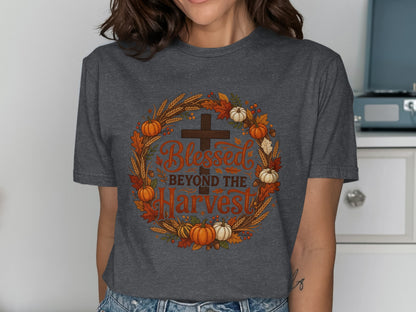 Dark gray t-shirt with a circular harvest-themed design featuring a cross and "Blessed Beyond the Harvest" text.
