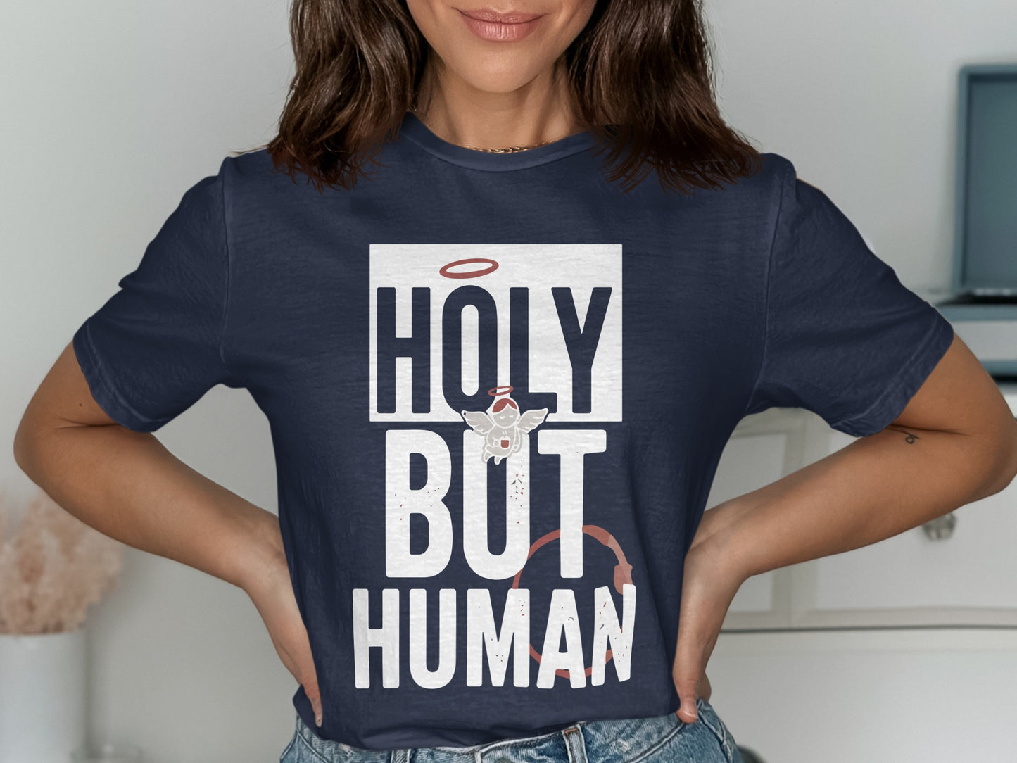 Navy t-shirt with "HOLY BUT HUMAN" text and halo graphic.