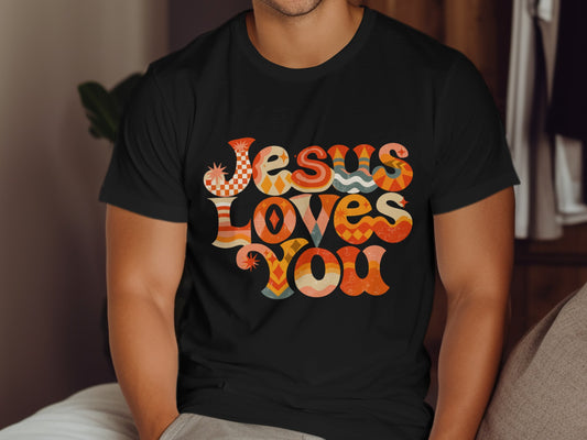 Black t-shirt with retro "Jesus Loves You" text design in colorful geometric patterns.