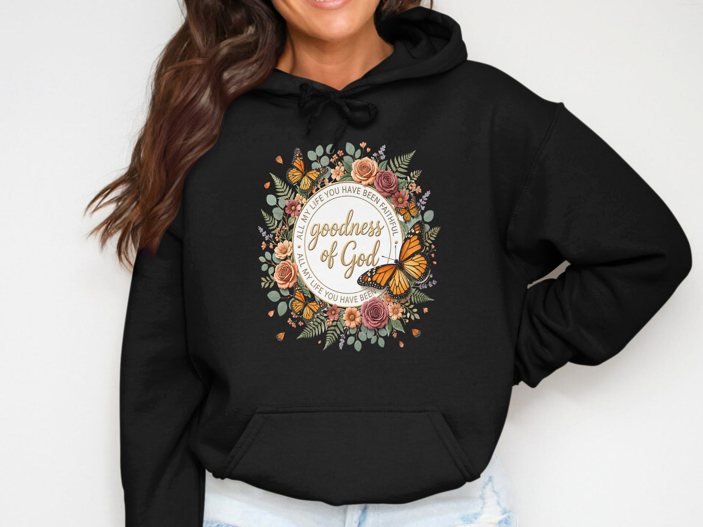 Black hoodie with floral wreath and "Goodness of God" text.