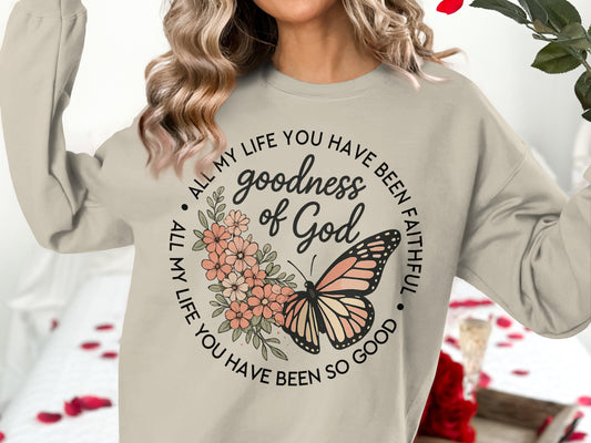 Cream sweatshirt with floral butterfly graphic and text "goodness of God".