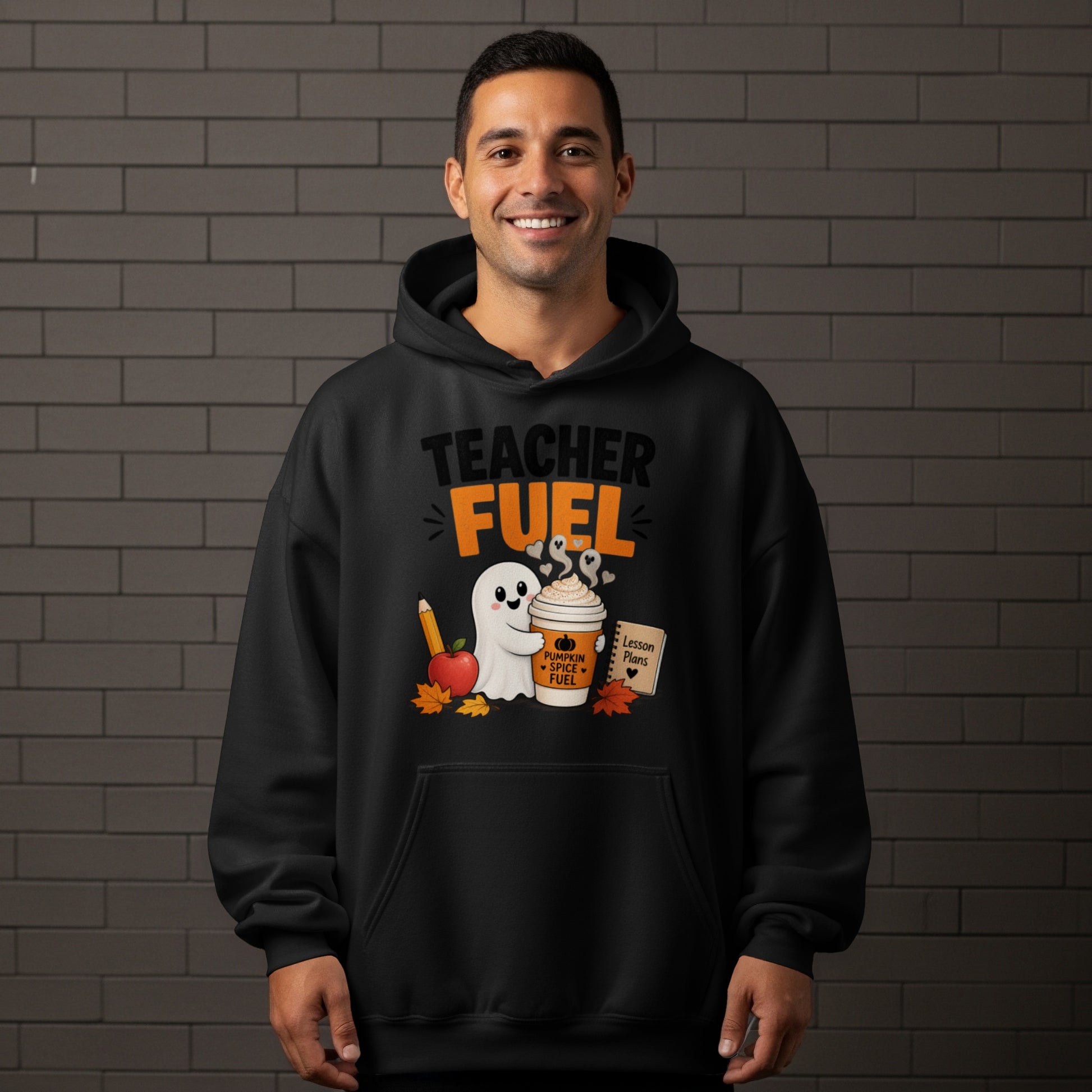 Black hoodie with "Teacher Fuel" text, ghost, coffee cup, and school supplies graphic.