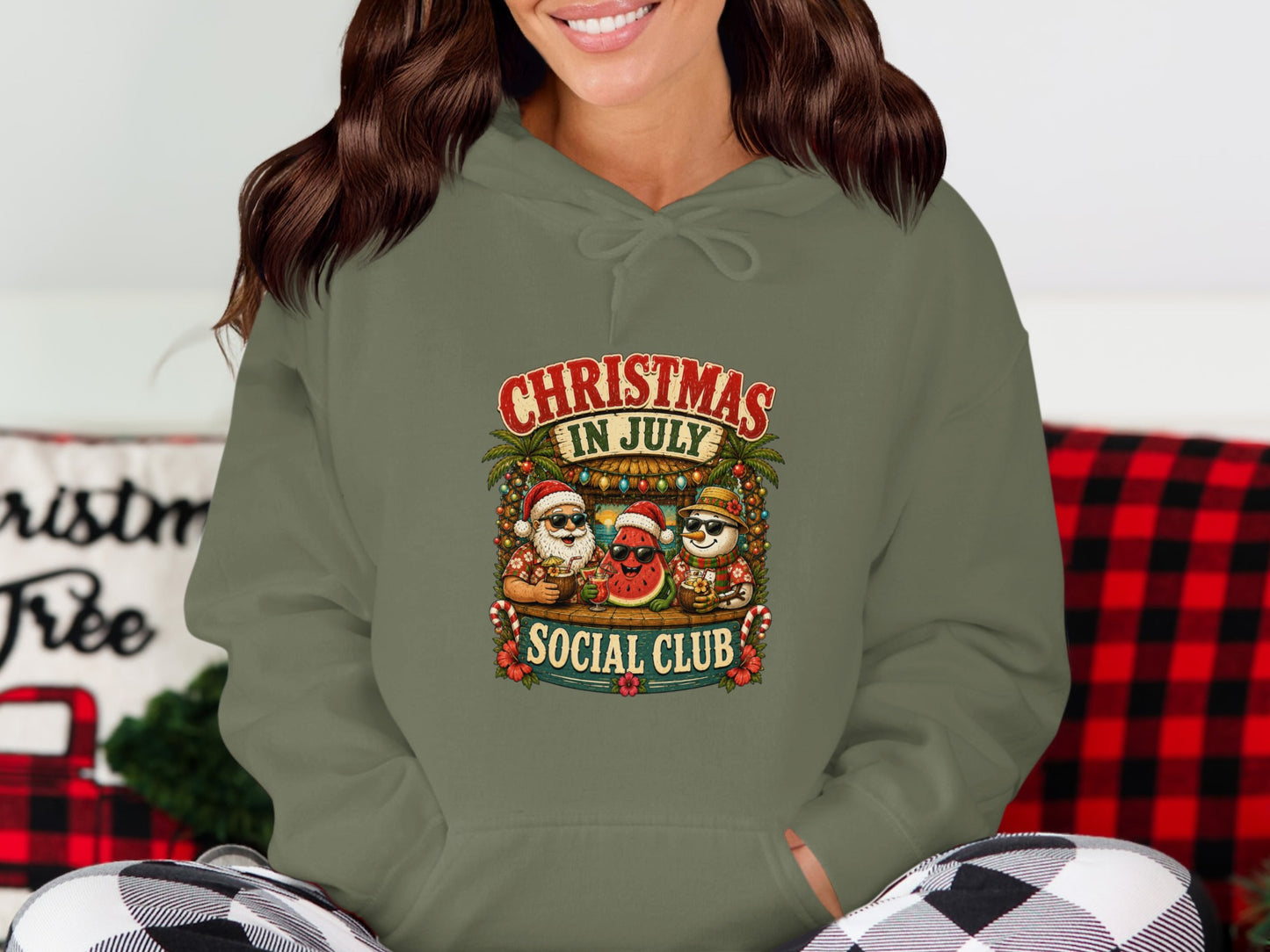 Holiday graphic featuring Santa, a snowman, and a palm tree on a green hoodie.