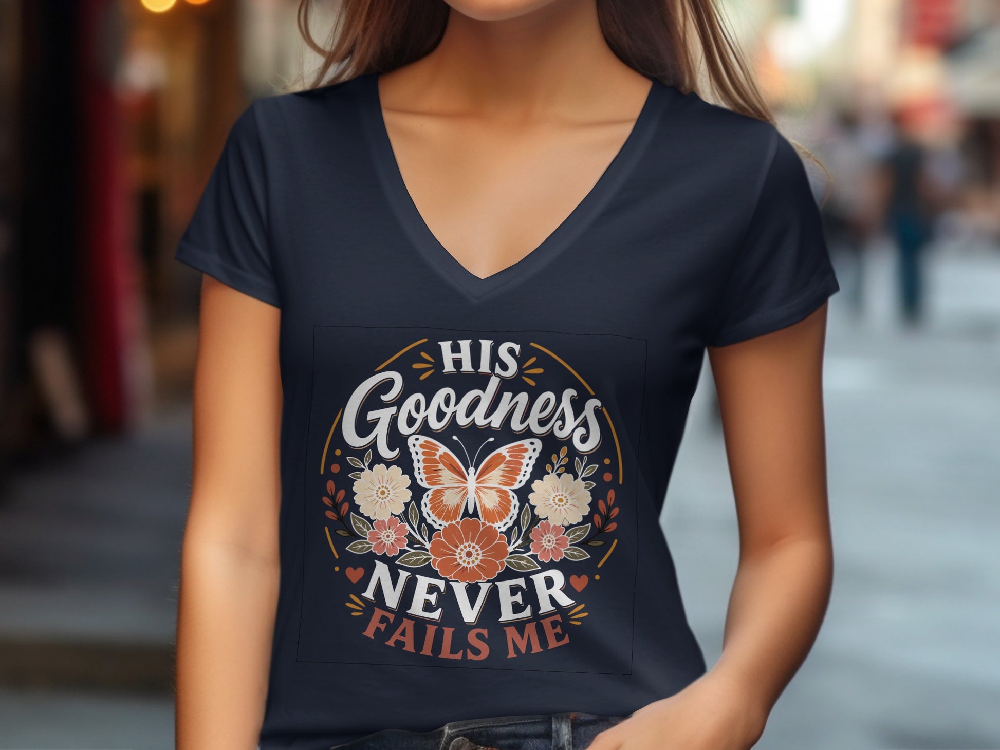 Dark blue v-neck t-shirt with orange floral graphic and text "HIS GOODNESS NEVER FAILS ME".