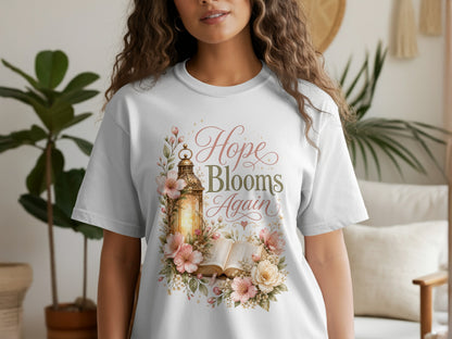 White t-shirt with "Hope Blooms Again" text and floral lantern design.