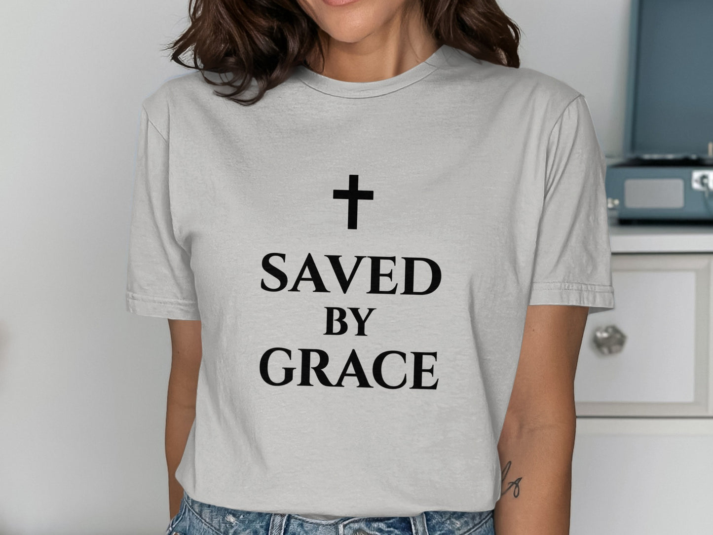 Gray t-shirt with black text: "SAVED BY GRACE" and a cross.
