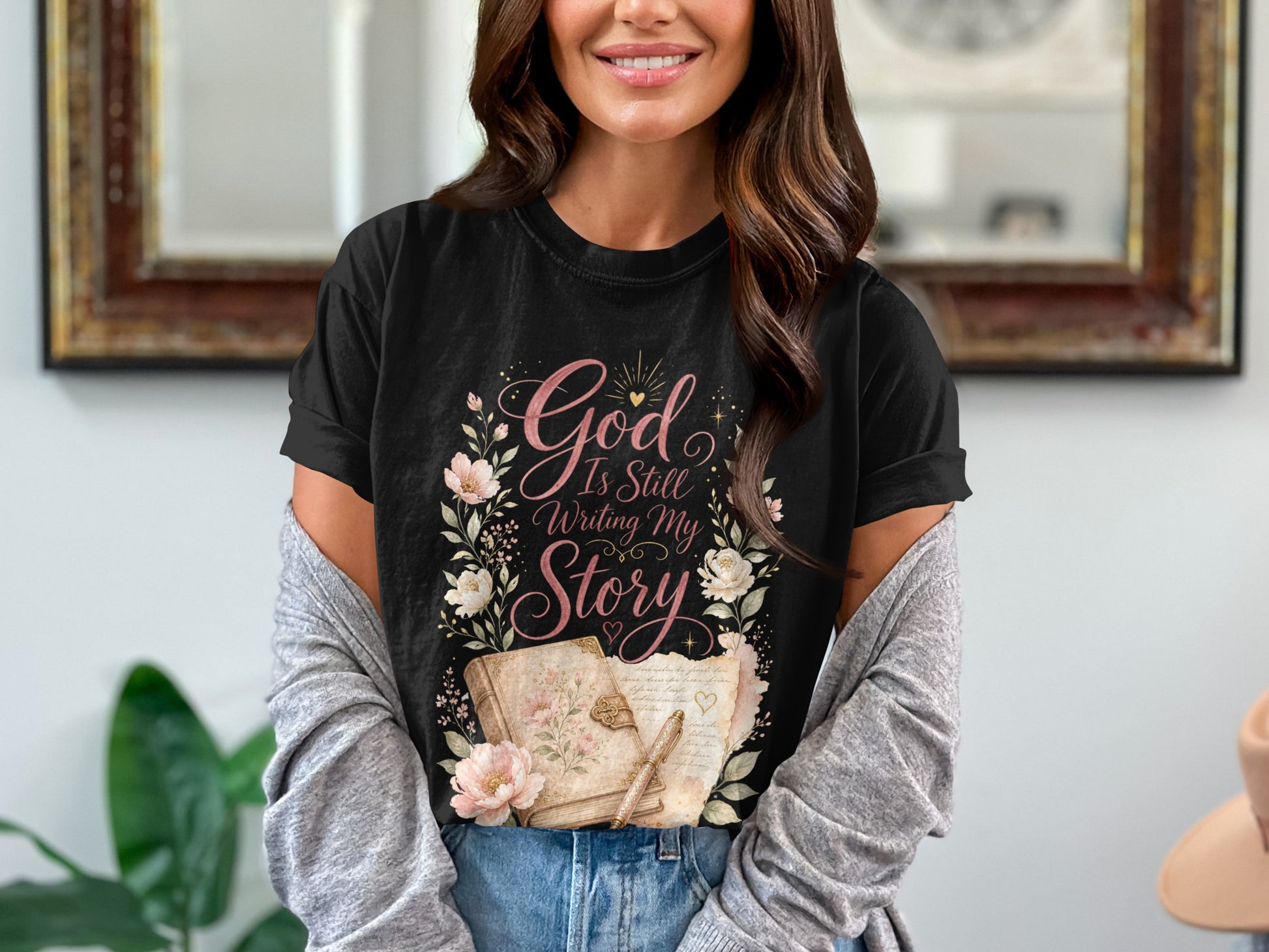 Black t-shirt with floral design and "God Is Still Writing My Story."