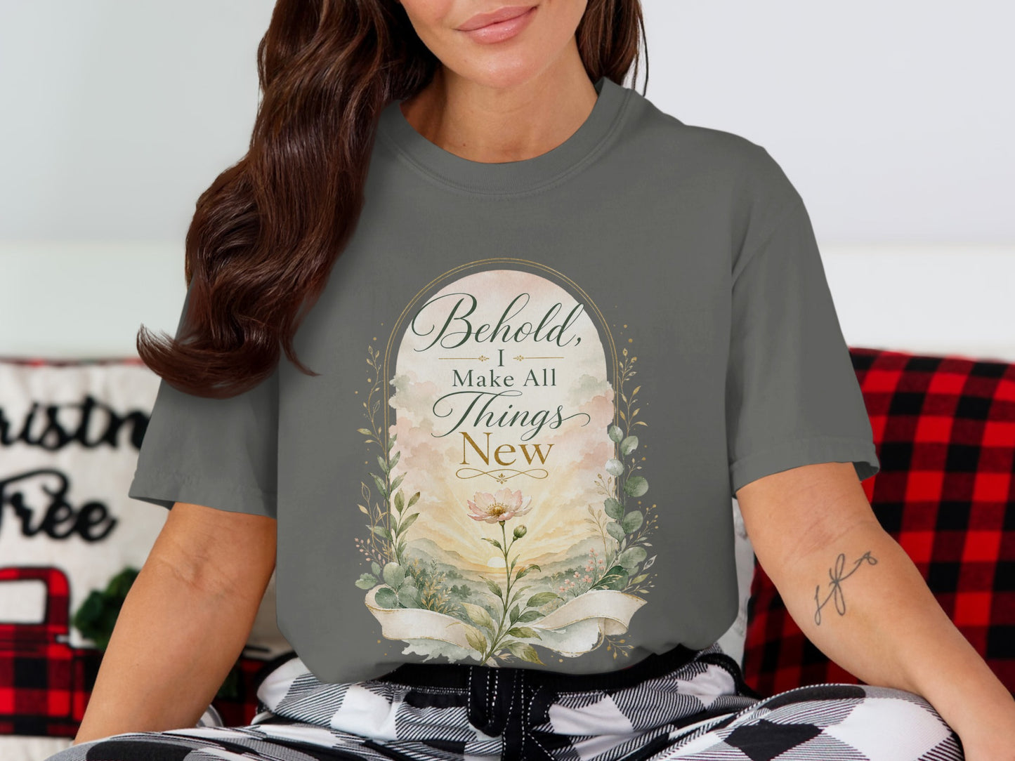 Gray t-shirt featuring a floral sunrise design with text "Behold, I Make All Things New."