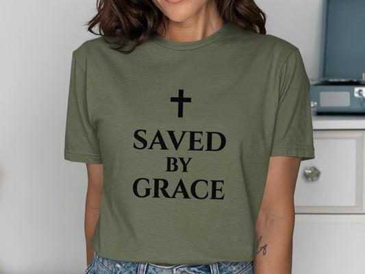 Olive green t-shirt with "SAVED BY GRACE" and a cross.