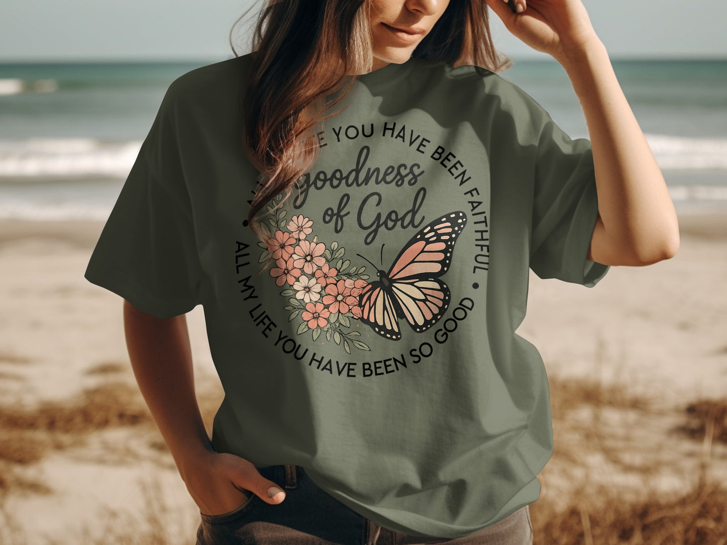 Olive green t-shirt with butterfly and "goodness of God" text design.