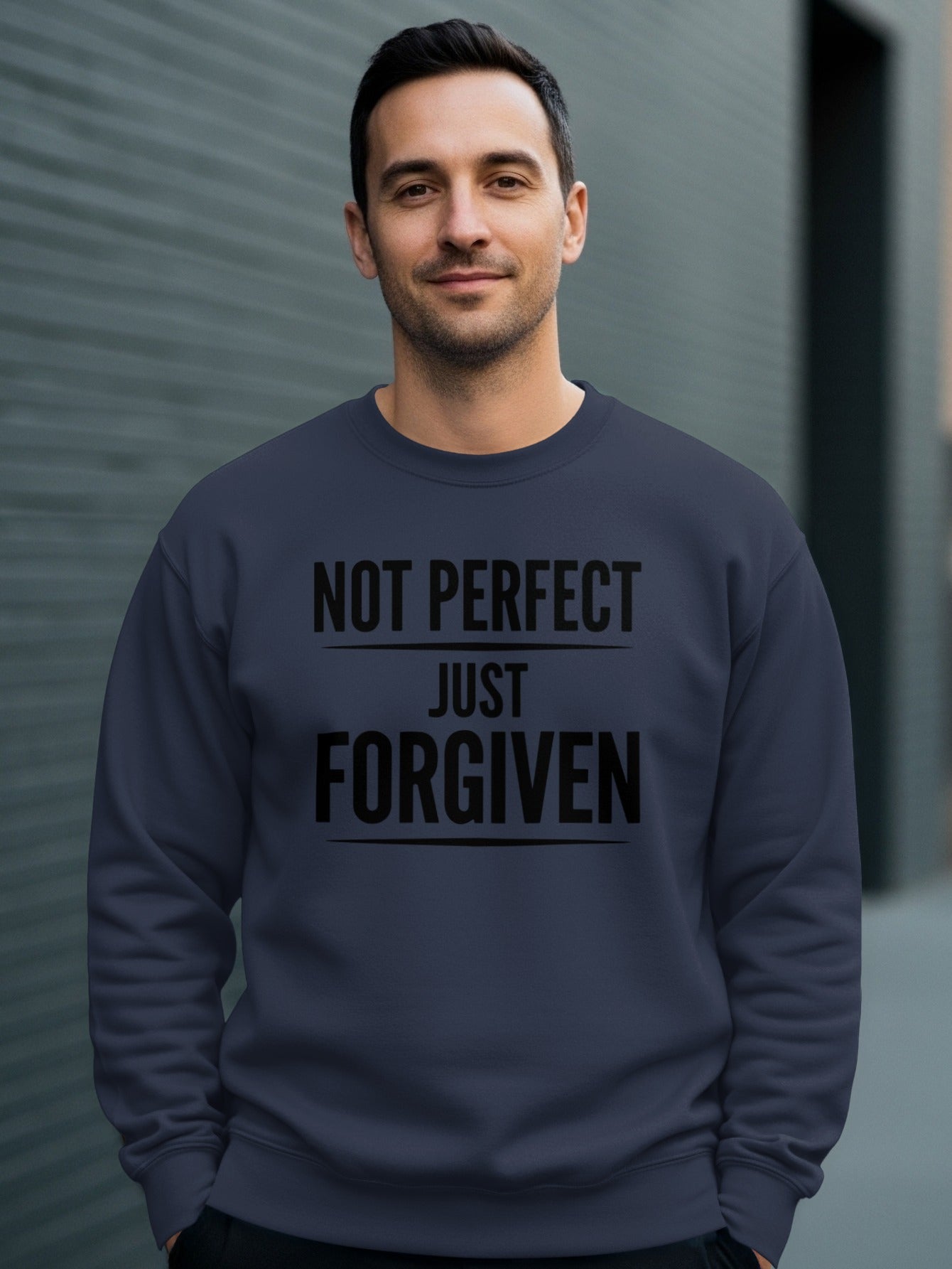 Navy sweatshirt with "NOT PERFECT JUST FORGIVEN" printed on chest.