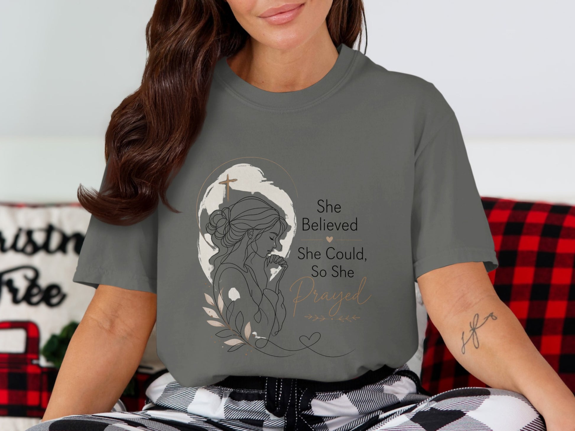 Graphic tee with a drawing of a woman praying and text "She Believed She Could, So She Prayed".