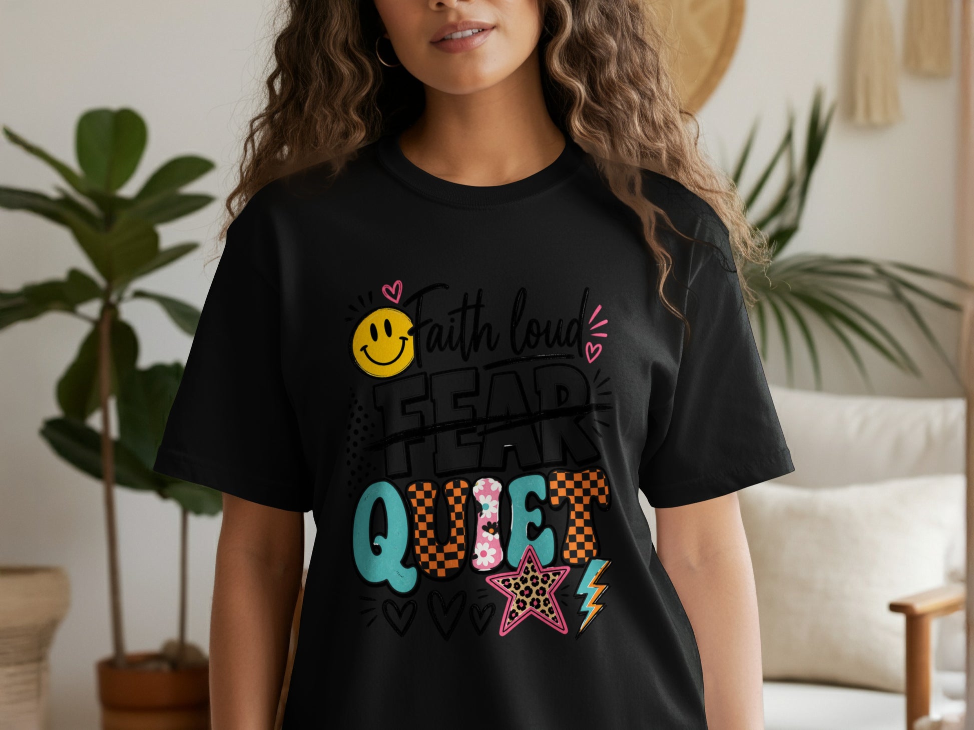 Black t-shirt with "Faith loud FEAR QUIET" text and graphic designs.