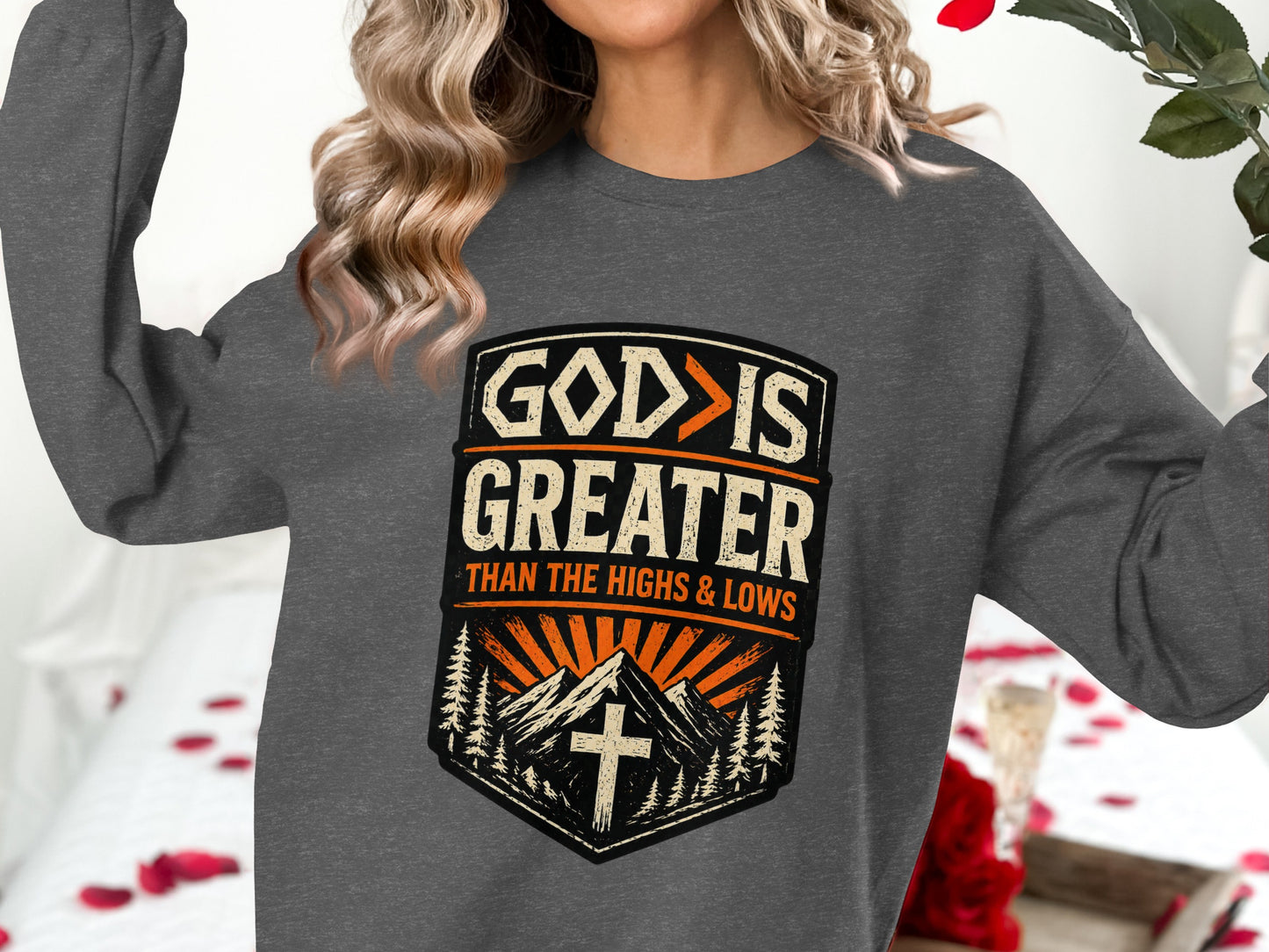 Gray sweatshirt with "GOD IS GREATER THAN THE HIGHS & LOWS" text and mountain graphic.