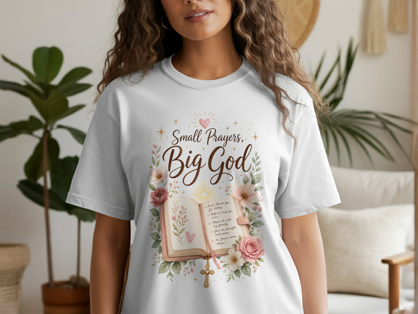White t-shirt with "Small Prayers, Big God" featuring an open bible, flowers, and a cross.