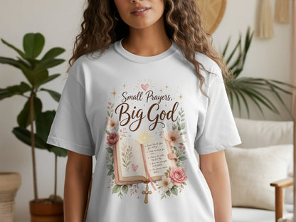 White t-shirt with "Small Prayers, Big God" featuring an open bible, flowers, and a cross.